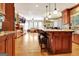 Spacious kitchen with wooden cabinets, granite countertops, and breakfast bar at 102 Passage Point, Peachtree City, GA 30269