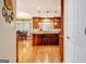 View of a bright kitchen with wood cabinets, granite counters, stainless steel appliances, and a kitchen island with bar stool seating at 102 Passage Point, Peachtree City, GA 30269