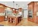 Bright kitchen features a large island with seating, stainless steel appliances, and custom wood cabinets at 102 Passage Point, Peachtree City, GA 30269