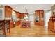 An open kitchen showcasing custom wood cabinets, granite counters, stainless steel appliances and hardwood flooring at 102 Passage Point, Peachtree City, GA 30269