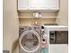 Efficient laundry area with side-by-side washer and dryer units for easy chore management at 102 Passage Point, Peachtree City, GA 30269