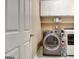 Practical laundry room equipped with modern washer and dryer and ample storage at 102 Passage Point, Peachtree City, GA 30269