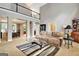 Open-concept living room with high ceilings, neutral carpet, and views of the dining room at 102 Passage Point, Peachtree City, GA 30269