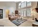 Inviting living room with high ceilings, fireplace, and access to outdoor space at 102 Passage Point, Peachtree City, GA 30269