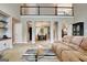 Bright living room with staircase, neutral carpet, and views of the dining room at 102 Passage Point, Peachtree City, GA 30269