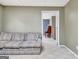 Comfortable living room with doorway to another room, providing versatile options for relaxing and entertaining at 102 Passage Point, Peachtree City, GA 30269