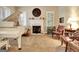 Bright living room with a grand piano, fireplace with mantel decor, and classic furniture at 102 Passage Point, Peachtree City, GA 30269