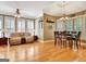 Open-concept living room with ample natural light, hardwood floors, and multiple seating areas for comfortable living at 102 Passage Point, Peachtree City, GA 30269