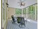 Covered porch with seating and ceiling fan, perfect for enjoying the outdoors in comfort at 102 Passage Point, Peachtree City, GA 30269