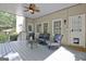 Comfortable, covered porch with seating, fan, and convenient access through two doors, ideal for relaxing or entertaining at 102 Passage Point, Peachtree City, GA 30269