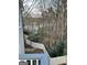 View of natural backyard with trees, lake, and privacy fence at 102 Passage Pt, Peachtree City, GA 30269