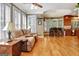 Comfortable living room showcases hardwood floors, plantation shutters, and seamless flow into the kitchen area at 102 Passage Pt, Peachtree City, GA 30269