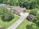 Aerial view of a brick single-Gathering home with an attached garage, long driveway, and mature landscaping at 186 Ashley Dr, Mcdonough, GA 30252