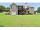 Spacious backyard with a red brick house, screened porch, and stairs leading to a garage at 186 Ashley Dr, Mcdonough, GA 30252