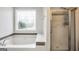 Bathtub with decorative window and separate shower at 186 Ashley Dr, Mcdonough, GA 30252