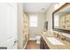Bathroom with granite countertop, dark wood cabinet, tile flooring and beach themed shower curtain at 186 Ashley Dr, Mcdonough, GA 30252
