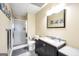 Bathroom with a shower, decorative ocean themed art, tile floor, and vanity with granite countertop at 186 Ashley Dr, Mcdonough, GA 30252