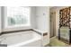Bathtub with decorative window and separate shower at 186 Ashley Dr, Mcdonough, GA 30252