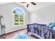 Bedroom with large window, hardwood floors and ceiling fan at 186 Ashley Dr, Mcdonough, GA 30252
