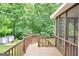 Wooden deck with brown railings overlooking lush greenery at 186 Ashley Dr, Mcdonough, GA 30252