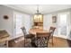 Cozy dining area with wood table, four chairs, chandelier, and built-in cabinet at 186 Ashley Dr, Mcdonough, GA 30252