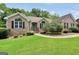 Well-maintained brick home featuring lush green lawn, landscape beds, and a charming walkway at 186 Ashley Dr, Mcdonough, GA 30252