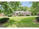 Beautiful brick home with mature trees, green lawn, and manicured shrubbery at 186 Ashley Dr, Mcdonough, GA 30252