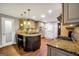 Gourmet kitchen featuring granite countertops, stainless steel appliances, and a breakfast bar at 186 Ashley Dr, Mcdonough, GA 30252
