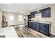 Kitchen features dark cabinets, stainless steel refrigerator and luxury vinyl plank flooring at 186 Ashley Dr, Mcdonough, GA 30252