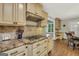 Modern kitchen with stainless steel stove top, tile backsplash, granite countertops and wood floors at 186 Ashley Dr, Mcdonough, GA 30252