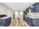 Kitchen features dark cabinets, white countertops and luxury vinyl plank flooring at 186 Ashley Dr, Mcdonough, GA 30252