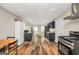 Kitchen features dark cabinets, stainless steel stove and luxury vinyl plank flooring at 186 Ashley Dr, Mcdonough, GA 30252
