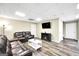 Spacious living room features a sofa, loveseat, TV, and luxury vinyl plank flooring at 186 Ashley Dr, Mcdonough, GA 30252