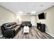 Spacious living room features a sofa, loveseat, TV, and luxury vinyl plank flooring at 186 Ashley Dr, Mcdonough, GA 30252
