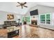 Cozy living room boasts a fireplace, hardwood floors, and natural light from large windows at 186 Ashley Dr, Mcdonough, GA 30252