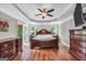 Main bedroom featuring hardwood floors, trey ceiling, ceiling fan, and access to a screened porch at 186 Ashley Dr, Mcdonough, GA 30252
