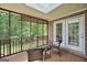 Inviting screened-in patio with wicker furniture and serene backyard views at 186 Ashley Dr, Mcdonough, GA 30252