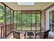 Inviting screened-in patio with wicker furniture and serene backyard views at 186 Ashley Dr, Mcdonough, GA 30252