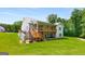 Back of house featuring a spacious deck, well-maintained lawn, and outdoor seating at 30 Hollyhock Ln, Covington, GA 30014