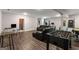 Spacious finished basement area features a foosball table, leather seating, and wood-look flooring at 30 Hollyhock Ln, Covington, GA 30014