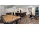Finished basement with billiard table, exercise bike, and leather couch perfect for entertaining at 30 Hollyhock Ln, Covington, GA 30014