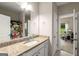 Bright bathroom features granite counters, white cabinetry, and an open view to the adjacent office space at 30 Hollyhock Ln, Covington, GA 30014
