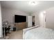 Neutral-toned bedroom features large television, comfortable chair, and a peaceful ambiance at 30 Hollyhock Ln, Covington, GA 30014