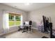 Well-lit bedroom used as an office with a large window overlooking a grassy yard at 30 Hollyhock Ln, Covington, GA 30014
