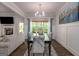 Bright dining room with large windows, a view to the living room, and stylish decor at 30 Hollyhock Ln, Covington, GA 30014