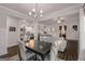Dining room with modern chandelier and view to living room at 30 Hollyhock Ln, Covington, GA 30014