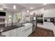 Modern kitchen with stainless steel appliances, granite counters, and a large farmhouse sink at 30 Hollyhock Ln, Covington, GA 30014