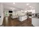 Open-concept kitchen featuring granite counters, stainless appliances, and a large island at 30 Hollyhock Ln, Covington, GA 30014