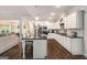 Modern kitchen with stainless appliances, a large island, and open-concept living at 30 Hollyhock Ln, Covington, GA 30014
