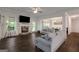 Bright living room featuring a fireplace, large windows, and hardwood floors at 30 Hollyhock Ln, Covington, GA 30014